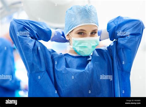 Young female surgeon tying her surgical mask Stock Photo, Royalty Free Image: 133496799 - Alamy