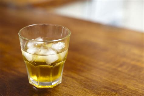Free Image of Liquor Concept - Glass of Whiskey with Ice | Freebie.Photography