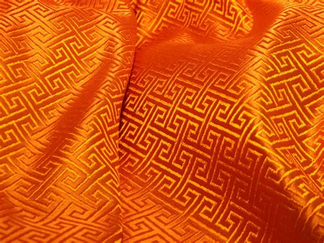 Chinese SILK brocade fabric in vibrant orange with a