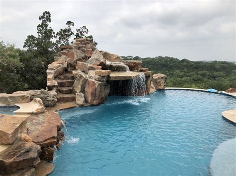 Huge Rock Waterfall | Swimming pool slides, Swimming pool builder, Rock waterfall