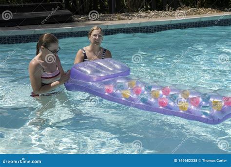 Two Women Work on a Flotation Device in a Pooll Editorial Stock Photo - Image of work, pool ...