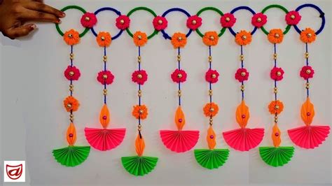 Wall hanging Toran for Diwali, Deepawali home decoration craft from paper Diya and wool