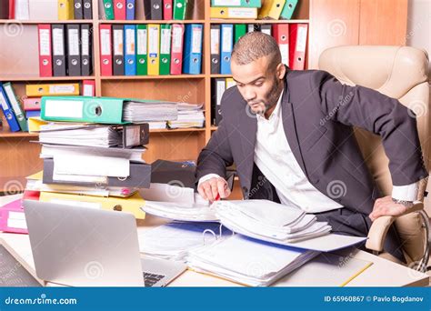 Very busy man in office stock image. Image of document - 65960867