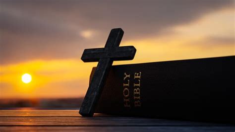 Premium Photo | Concept background with cross and bible for prayer on sunset background3d rendering