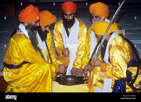 Sikh amrit ceremony with five men symbolising the original five `holy ...