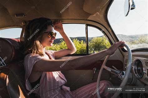 Woman driving a vintage car — journey, trip - Stock Photo | #222718700