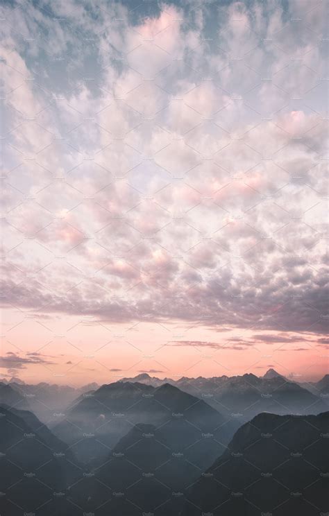 Sunset sky clouds over mountains | Nature Stock Photos ~ Creative Market