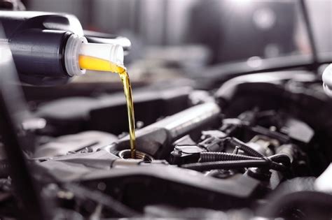 Premium Photo | Motor oil pouring to car engine.