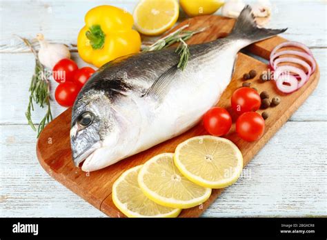 Fresh raw fish and food ingredients on table Stock Photo - Alamy