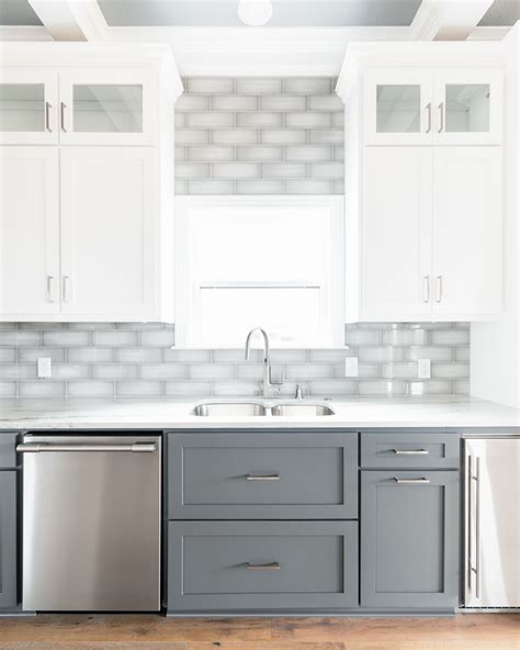 Two tone white and dark gray shaker cabinets with gray subway tile ...