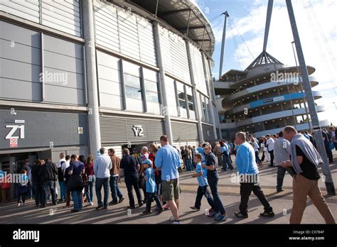 Fans queue outside the Etihad Stadium, Manchester City Football Club ...