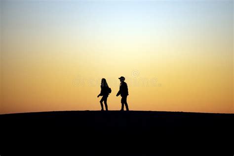 Two People Walking Together at Sunset Stock Image - Image of silhouettes, horizon: 168477797