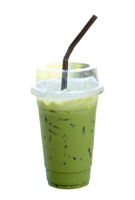 Iced matcha green tea Latte with condensed milk in transparent plastic glass isolated with ...