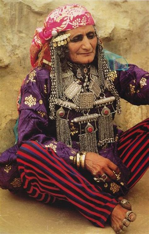 Elderly Bedouin woman wearing traditional clothes and jewelry, Yemen ...