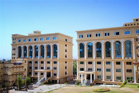 two large buildings with many windows on the front and side of each ...