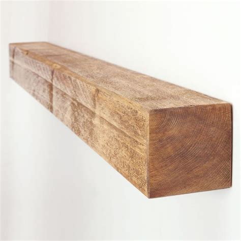 a wooden shelf hanging on the wall with white walls in the background ...