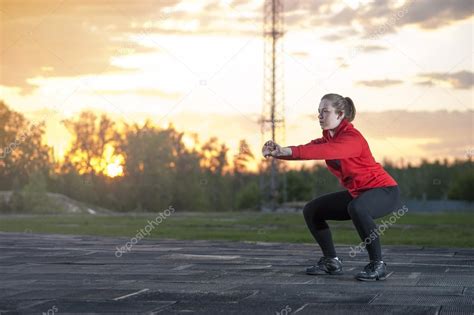 Fit woman doing squats outdoors Stock Photo by ©by_ShiShkin 113502596