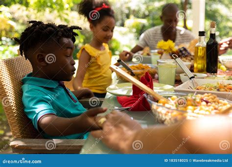 Family Eating Together at Table Stock Image - Image of sunny, four: 183518025