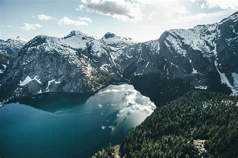 HD wallpaper: aerial photo of lake surrounded by alpine mountains ...