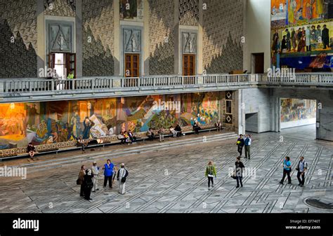 Visitors looking at the murals in the main hall of Oslo City Hall, Oslo, Norway Stock Photo - Alamy