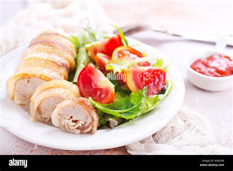 chicken roll with salad on the white plate Stock Photo - Alamy