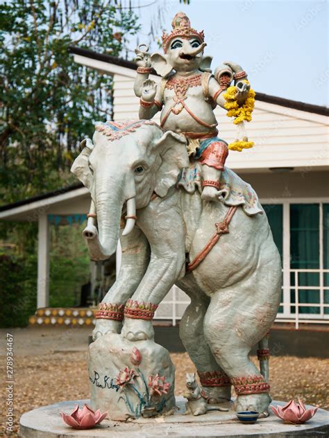 Statue of an elephant with a rider in the Thai house courtyard. The ...