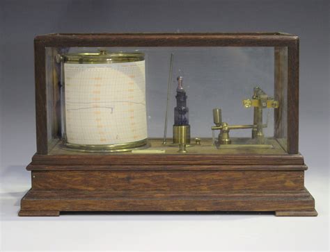 An early 20th century oak cased barograph with brass mechanism and ...