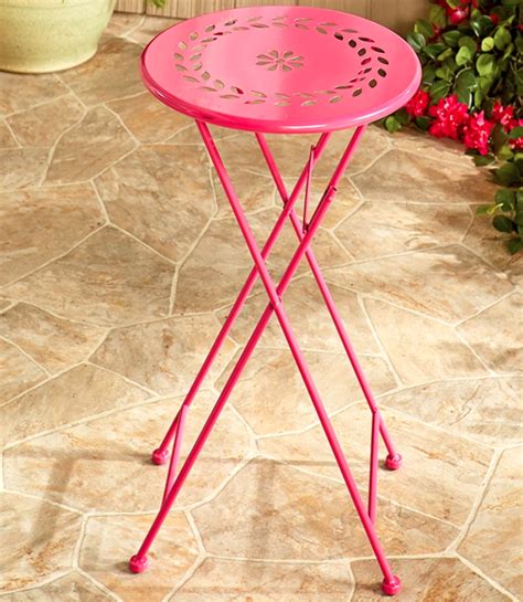 a pink table sitting on top of a stone floor