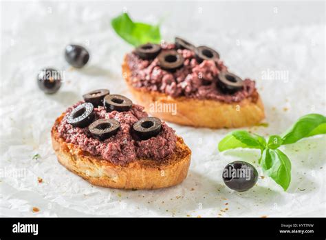 Fresh bruschetta with black olives for a snack Stock Photo - Alamy