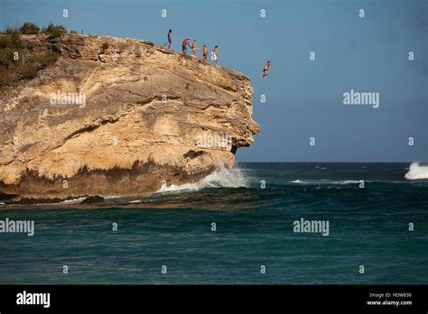 Cliff jumping, Keoniloa Beach and Bay, also known as Ship Wreck Beach ...