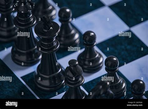 Black chess pieces on a chessboard Stock Photo - Alamy