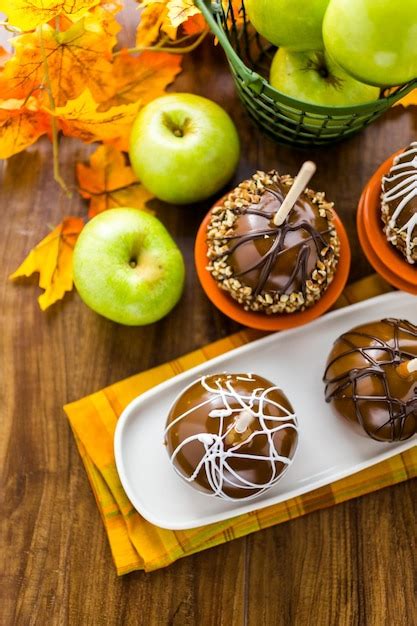 Premium Photo | Hand dipped caramel apples decorated for halloween.