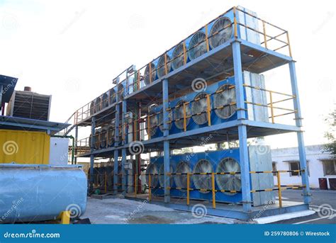 Exterior of a Warehouse with Huge Fans Stored Atop Each Other Stock Photo - Image of sunny ...