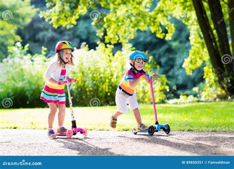 Kids Riding Scooter in Summer Park. Stock Image - Image of group, lifestyle: 89850351