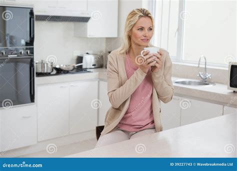 Thoughtful Woman Drinking Coffee in Kitchen Stock Image - Image of ...