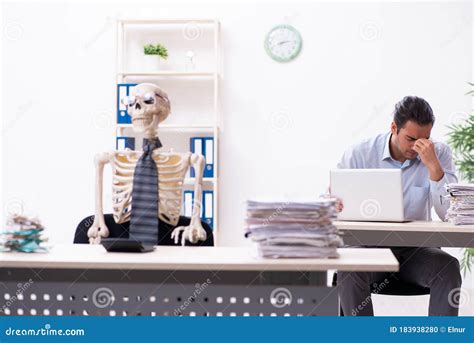 Young Male Employee and Skeleton in the Office Stock Photo - Image of ...