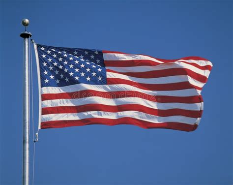 American Flag Flying From Flagpole Stock Photo - Image of justice, motion: 23151262