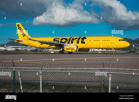 A Spirit Airlines Airbus A321 lines up for takeoff at St. Maarten SXM ...