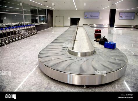 Baggage conveyor belt system area airport trolley passengers luggage Bengaluru international ...