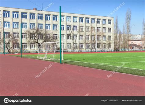 Soccer football field near urban school building Stock Photo by ©KleinElen 166908422