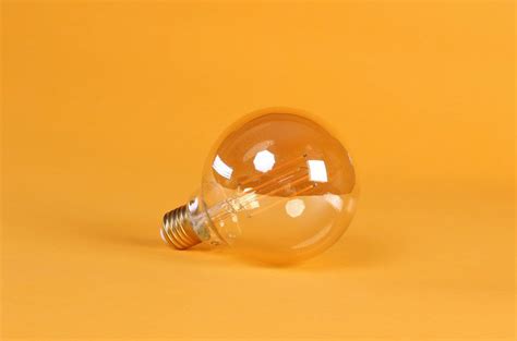 Yellow pencil on white background with drawn light bulb, concept of idea, solution or ...