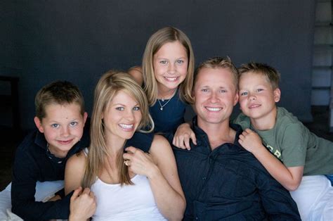 a family posing for a photo on the bed