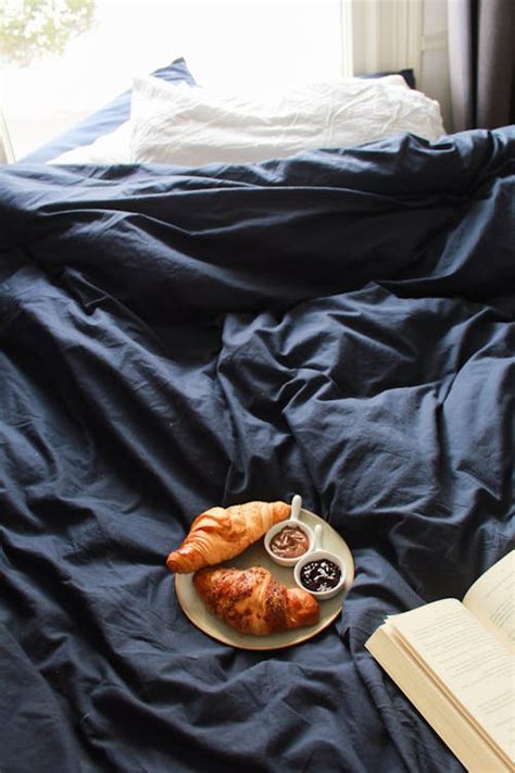 Crop woman with cup of coffee on bed · Free Stock Photo