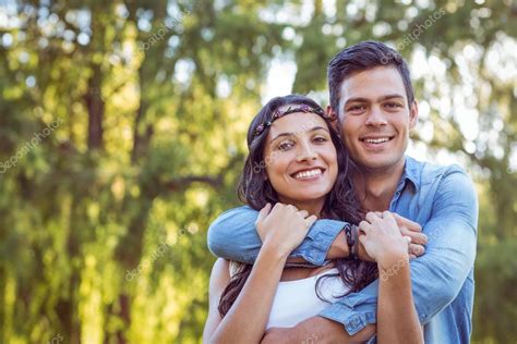 Cute couple smiling in the park — Stock Photo © Wavebreakmedia #76432935