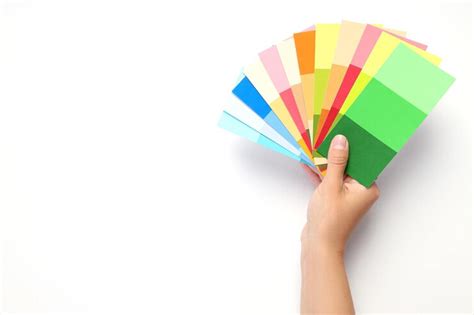 Premium Photo | Female hand holding color palettes on white background