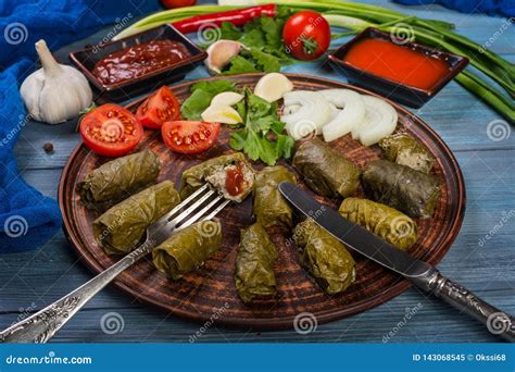 Dolma in grape leaves stock image. Image of cutlery - 143068545