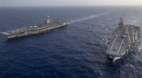 These photos of USS Gerald R. Ford and USS Harry S. Truman operating together highlight the ...