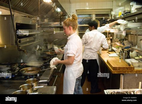 Team of restaurant kitchen staff busy at work Stock Photo - Alamy