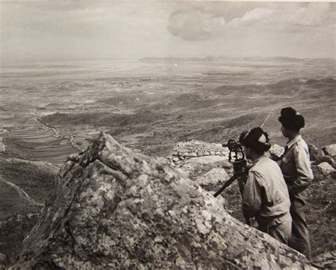 Two South Korean Army officers observe North Korean activity across the ...