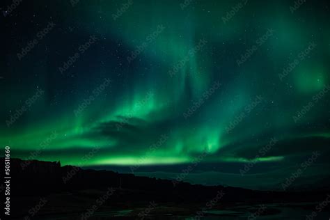 Northern lights above lagoon in Iceland Stock Photo | Adobe Stock